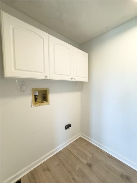 82 Haskins Ln N, Greece, NY 14468 - laundry area with cabinet space, wood finished floors, washer hookup, and baseboards