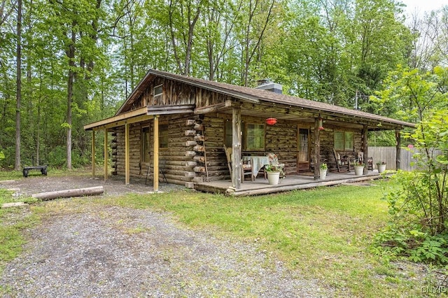 4090 Old Kennedy Rd, Onondaga, NY 13120 - exterior space with log siding, a chimney, and covered porch