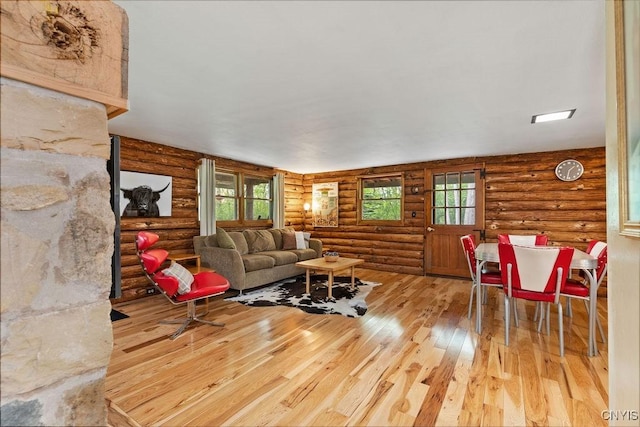 4090 Old Kennedy Rd, Onondaga, NY 13120 - living area featuring log walls, wood-type flooring, and plenty of natural light