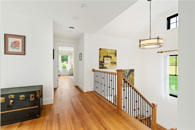 503 Grandview Ln, Milo, NY 14527 - hallway with baseboards, wood finished floors, and an upstairs landing