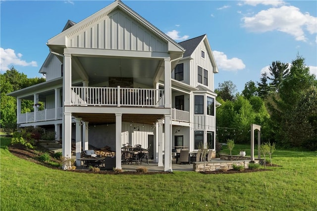 503 Grandview Ln, Milo, NY 14527 - back of house featuring board and batten siding, a patio area, a lawn, and a balcony