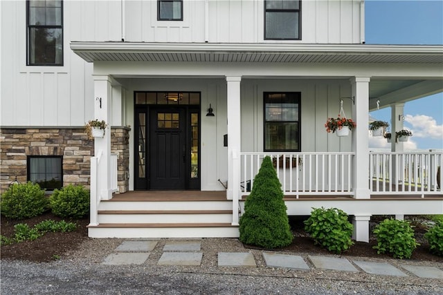 503 Grandview Ln, Milo, NY 14527 - entrance to property featuring board and batten siding, covered porch, and stone siding