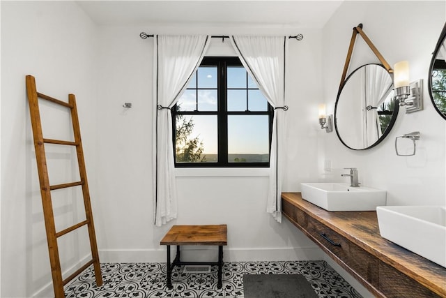 503 Grandview Ln, Milo, NY 14527 - bathroom with baseboards, double vanity, and tile patterned floors