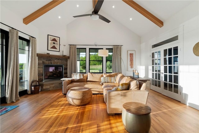 503 Grandview Ln, Milo, NY 14527 - living area with high vaulted ceiling, beamed ceiling, light wood finished floors, healthy amount of natural light, and a stone fireplace