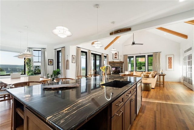 503 Grandview Ln, Milo, NY 14527 - kitchen with a sink, open floor plan, a glass covered fireplace, and wood finished floors