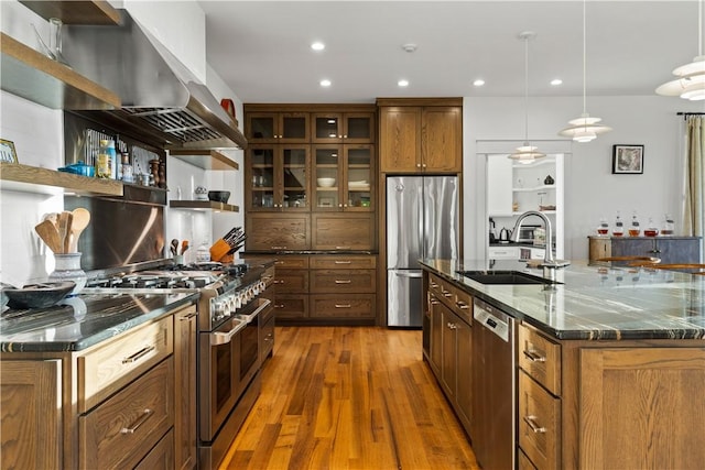 503 Grandview Ln, Milo, NY 14527 - kitchen with stainless steel appliances, a sink, wall chimney range hood, open shelves, and wood finished floors