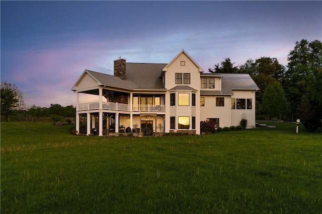 503 Grandview Ln, Milo, NY 14527 - back of property at dusk with a balcony, a lawn, and a chimney