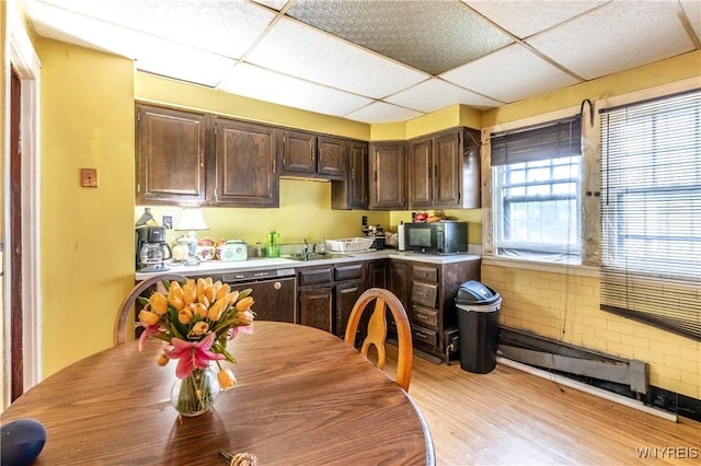 49 Mercer Ave, Buffalo, NY 14214 - kitchen with dark brown cabinets, a drop ceiling, a sink, light wood finished floors, and light countertops