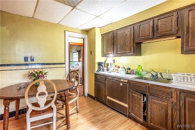 49 Mercer Ave, Buffalo, NY 14214 - kitchen with dishwasher, a sink, light wood-style flooring, light countertops, and a drop ceiling
