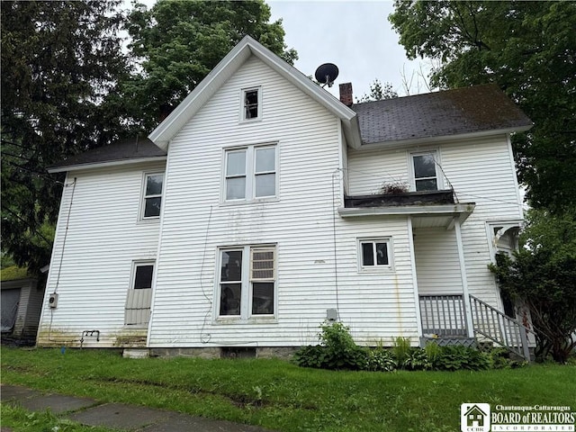 252 Fulton St, Jamestown, NY 14701 - rear view of property featuring a chimney, a lawn, entry steps, and roof with shingles