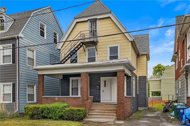 123 6th St, Niagara Falls, NY 14303 - view of front of home featuring a gambrel roof, brick siding, roof with shingles, and a porch