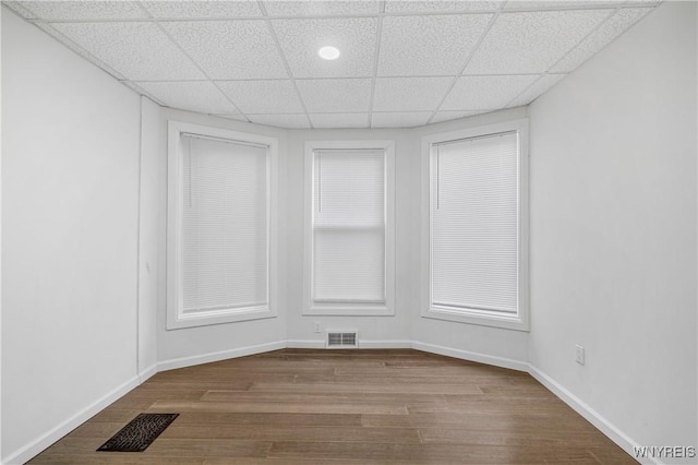 123 6th St, Niagara Falls, NY 14303 - spare room with a paneled ceiling, dark wood-style floors, and baseboards