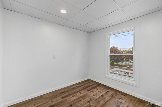 123 6th St, Niagara Falls, NY 14303 - spare room with wood finished floors, a paneled ceiling, and baseboards