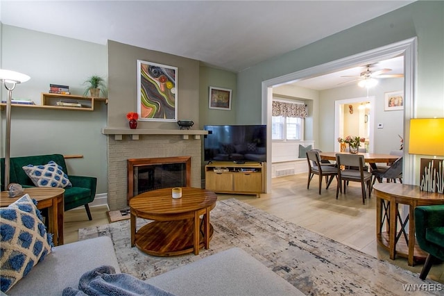 624 Buffalo Ave, Niagara Falls, NY 14303 - living room featuring wood finished floors, a fireplace, and ceiling fan