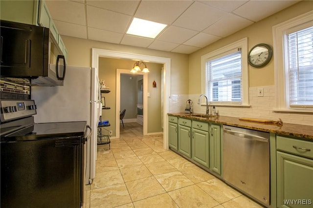 624 Buffalo Ave, Niagara Falls, NY 14303 - kitchen featuring appliances with stainless steel finishes, green cabinetry, a sink, tasteful backsplash, and dark stone countertops