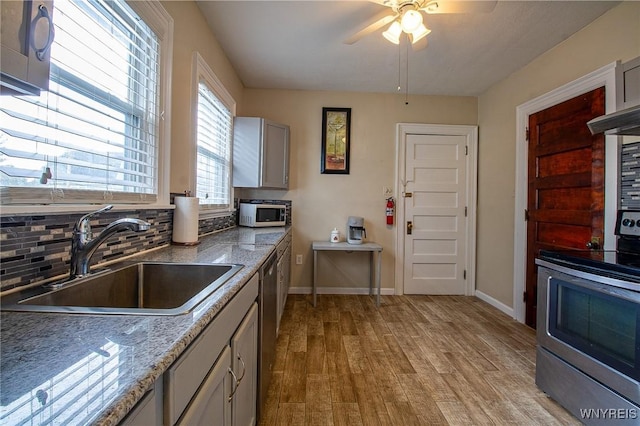 624 Buffalo Ave, Niagara Falls, NY 14303 - kitchen featuring appliances with stainless steel finishes, a sink, a ceiling fan, light wood-style floors, and baseboards