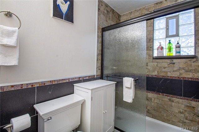 624 Buffalo Ave, Niagara Falls, NY 14303 - bathroom with a shower with shower door, toilet, tile walls, and a bathtub