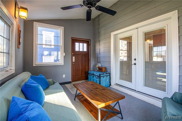 624 Buffalo Ave, Niagara Falls, NY 14303 - carpeted living area with lofted ceiling, french doors, a ceiling fan, wood walls, and baseboards