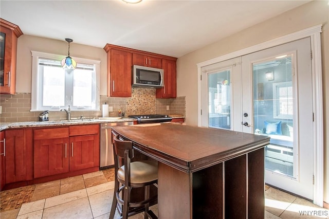 624 Buffalo Ave, Niagara Falls, NY 14303 - kitchen with stainless steel appliances, tasteful backsplash, hanging light fixtures, light stone countertops, and a sink