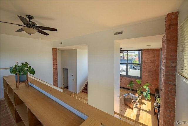 526 Plum St Unit 408, Syracuse, NY 13204 - hall featuring brick wall, wood finished floors, and stairs
