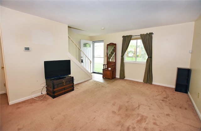 414 Fox Run, Gates, NY 14606 - unfurnished living room with carpet flooring, stairs, and baseboards