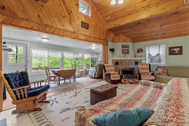 633 Eno Rd, Elbridge, NY 13080 - living area featuring lofted ceiling, healthy amount of natural light, a stone fireplace, and wood ceiling