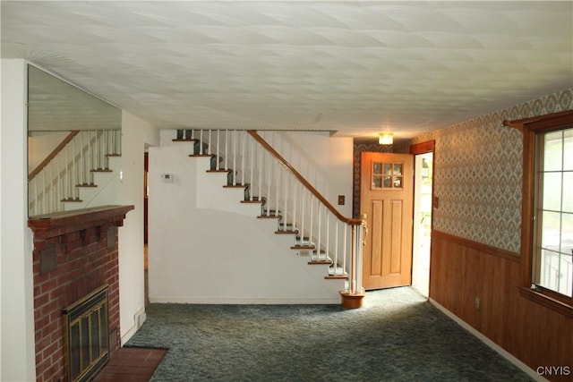 7 Catlin Ave, Paris, NY 13456 - stairs featuring a wainscoted wall, carpet, baseboards, a textured ceiling, and a brick fireplace
