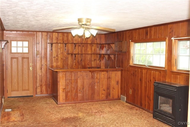 7 Catlin Ave, Paris, NY 13456 - unfurnished living room with wooden walls, ceiling fan, carpet floors, and baseboards