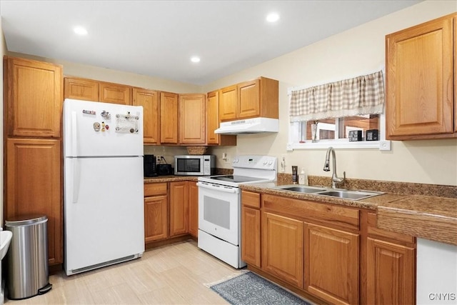 60 Cooper St, Lake George, NY 12845 - kitchen with white appliances, under cabinet range hood, a sink, recessed lighting, and brown cabinets