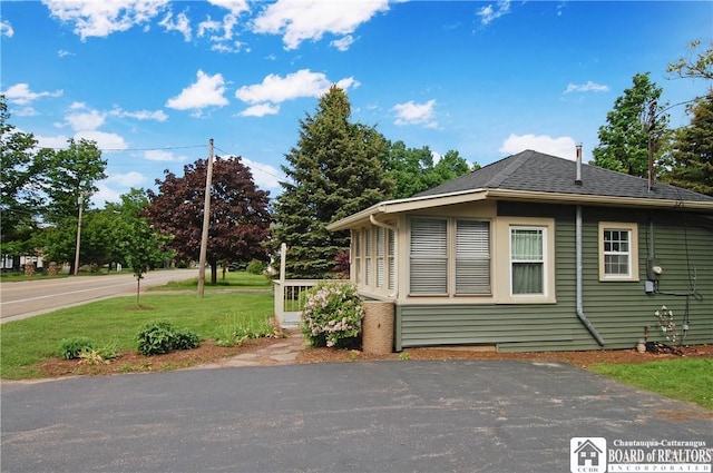 178 W Main St, Westfield, NY 14787 - view of side of home with a lawn and roof with shingles
