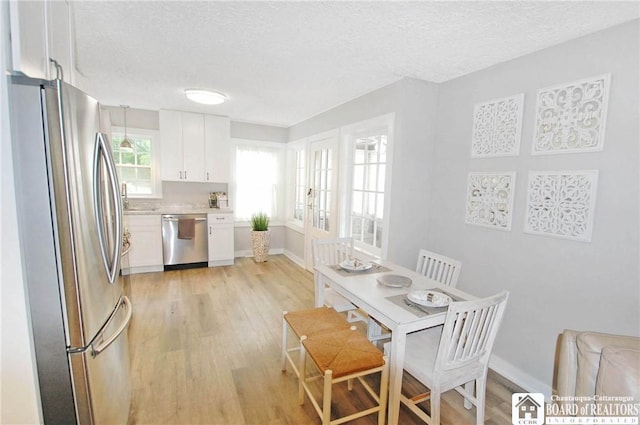 178 W Main St, Westfield, NY 14787 - dining area with a textured ceiling, light wood-style floors, and baseboards