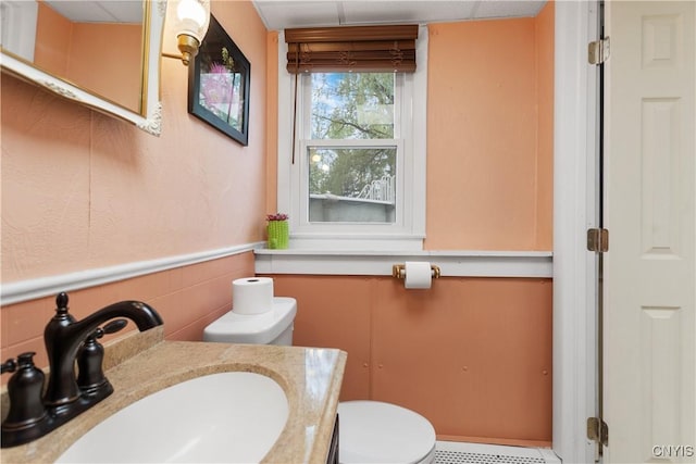 27 Cascade Dr, New Hartford, NY 13413 - bathroom featuring toilet, vanity, and wainscoting
