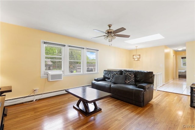 27 Cascade Dr, New Hartford, NY 13413 - living room featuring ceiling fan, a skylight, light wood-style floors, a chandelier, and cooling unit
