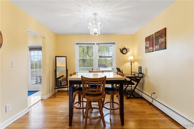 27 Cascade Dr, New Hartford, NY 13413 - dining space with a chandelier, a baseboard heating unit, light wood-style flooring, and baseboards