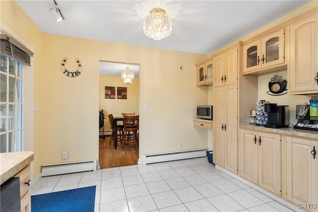 27 Cascade Dr, New Hartford, NY 13413 - kitchen featuring a chandelier, a baseboard heating unit, and light countertops