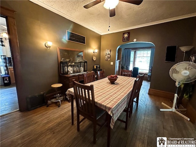 223 S 7th St, Olean-City, NY 14760 - dining area featuring arched walkways, a ceiling fan, wood-type flooring, a textured ceiling, and crown molding