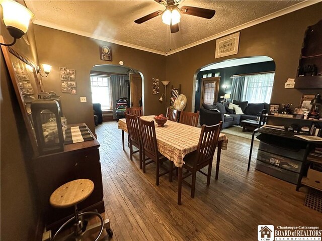 223 S 7th St, Olean-City, NY 14760 - dining room with arched walkways, a textured ceiling, a ceiling fan, wood-type flooring, and ornamental molding