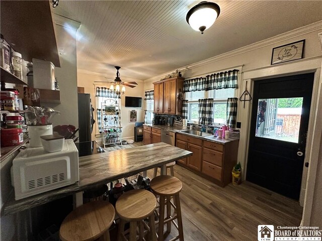 223 S 7th St, Olean-City, NY 14760 - kitchen featuring freestanding refrigerator, white microwave, ornamental molding, brown cabinetry, and dishwasher