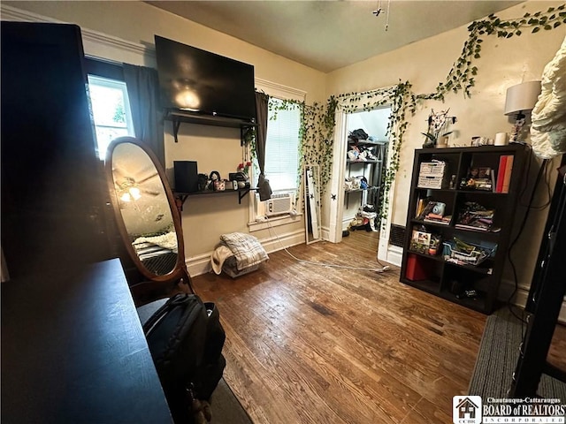 223 S 7th St, Olean-City, NY 14760 - living area featuring wood finished floors, healthy amount of natural light, baseboards, and cooling unit