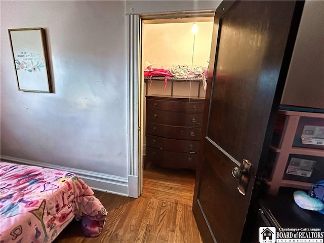 223 S 7th St, Olean-City, NY 14760 - bedroom featuring wood finished floors, a closet, a spacious closet, and baseboards