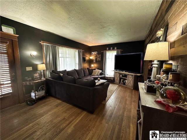 223 S 7th St, Olean-City, NY 14760 - living area with a textured ceiling and dark wood finished floors