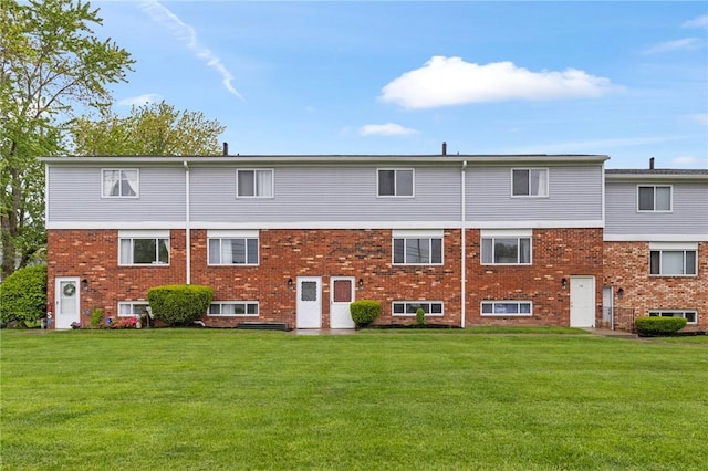 275 Owens Rd Unit 115, Sweden, NY 14420 - back of house featuring a yard and brick siding