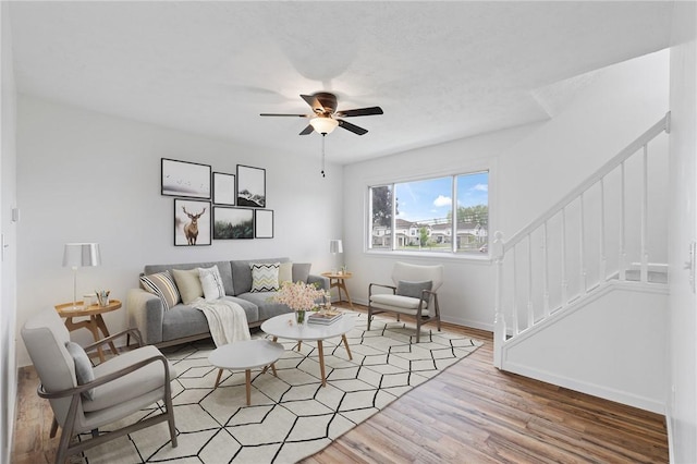 275 Owens Rd Unit 115, Sweden, NY 14420 - living area featuring stairway, ceiling fan, light wood-type flooring, and baseboards