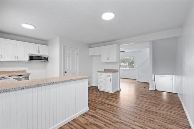 275 Owens Rd Unit 115, Sweden, NY 14420 - kitchen featuring appliances with stainless steel finishes, dark wood-style floors, white cabinets, and baseboards