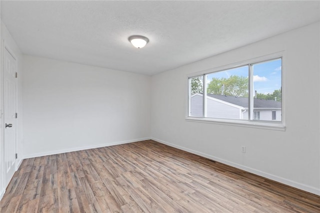 275 Owens Rd Unit 115, Sweden, NY 14420 - spare room with wood finished floors and baseboards