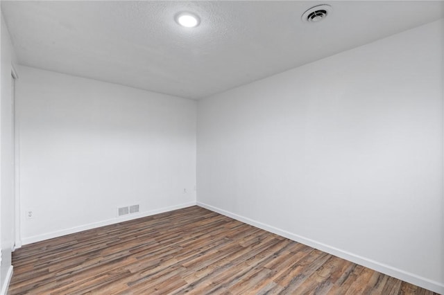 275 Owens Rd Unit 115, Sweden, NY 14420 - empty room featuring wood finished floors, baseboards, and a textured ceiling