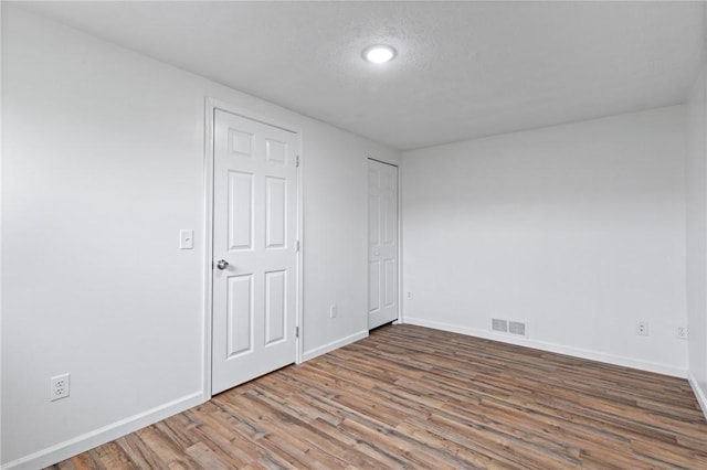 275 Owens Rd Unit 115, Sweden, NY 14420 - unfurnished bedroom featuring wood finished floors, baseboards, and recessed lighting