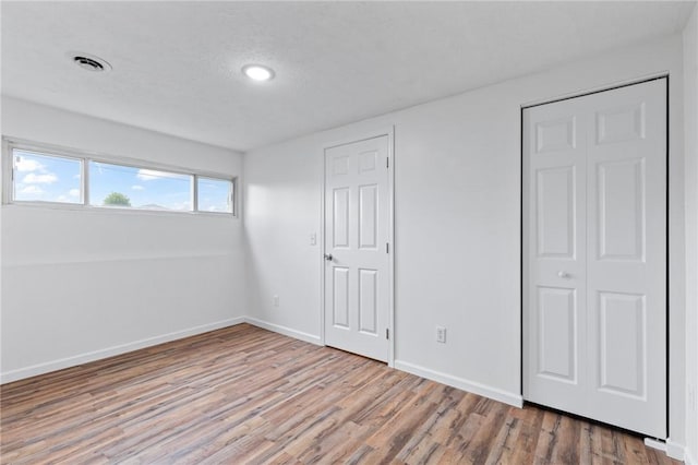 275 Owens Rd Unit 115, Sweden, NY 14420 - unfurnished bedroom featuring wood finished floors, baseboards, and recessed lighting