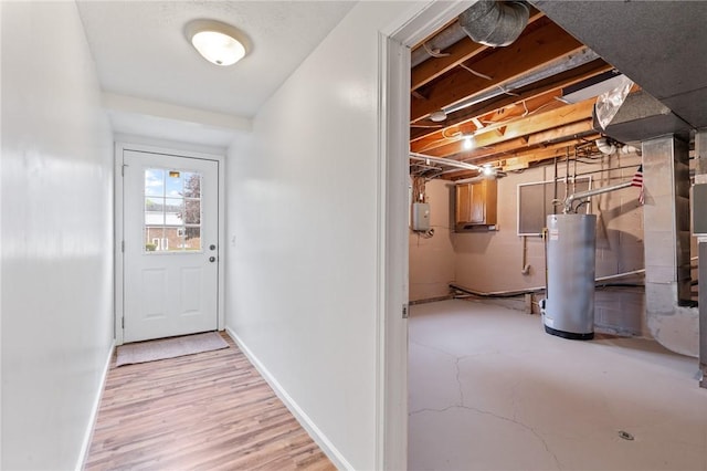 275 Owens Rd Unit 115, Sweden, NY 14420 - doorway to outside featuring gas water heater and baseboards