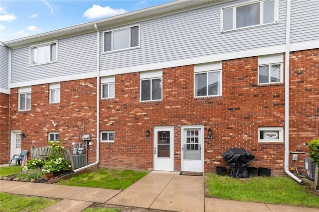 275 Owens Rd Unit 115, Sweden, NY 14420 - rear view of property featuring brick siding